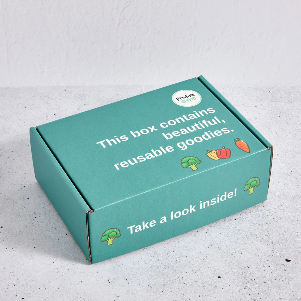 Green gift box with text and vegetable illustrations on a light grey background