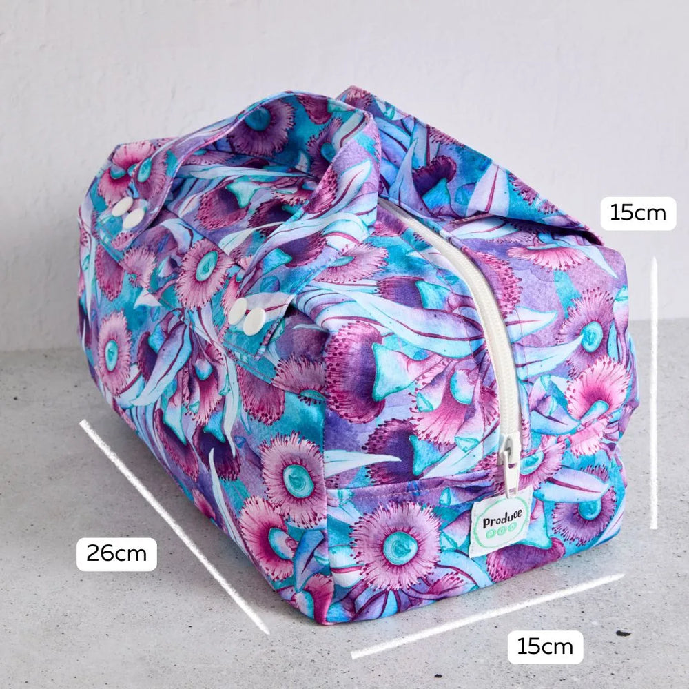 Floral-patterned reusable produce bag with measurements on a grey background