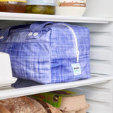 Purple reusable produce bag on a fridge shelf