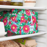 Pink floral reusable produce bag on a fridge shelf