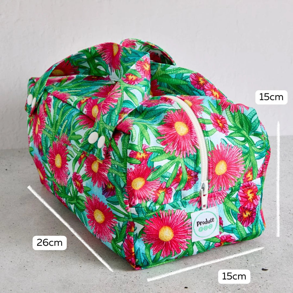 Floral-patterned reusable produce bag with measurements on a grey background