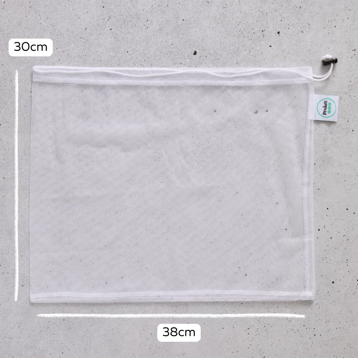 Mesh reusable produce bag with measurements on a grey surface