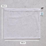 Mesh reusable produce bag with measurements on a grey surface