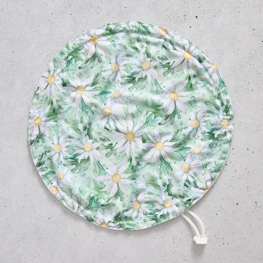 Flat bowl cover with floral pattern on a grey surface