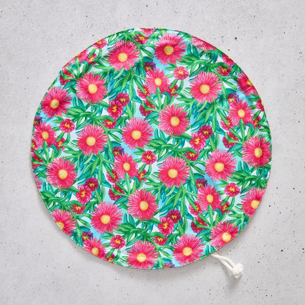 Flat bowl cover with floral pattern on a grey surface