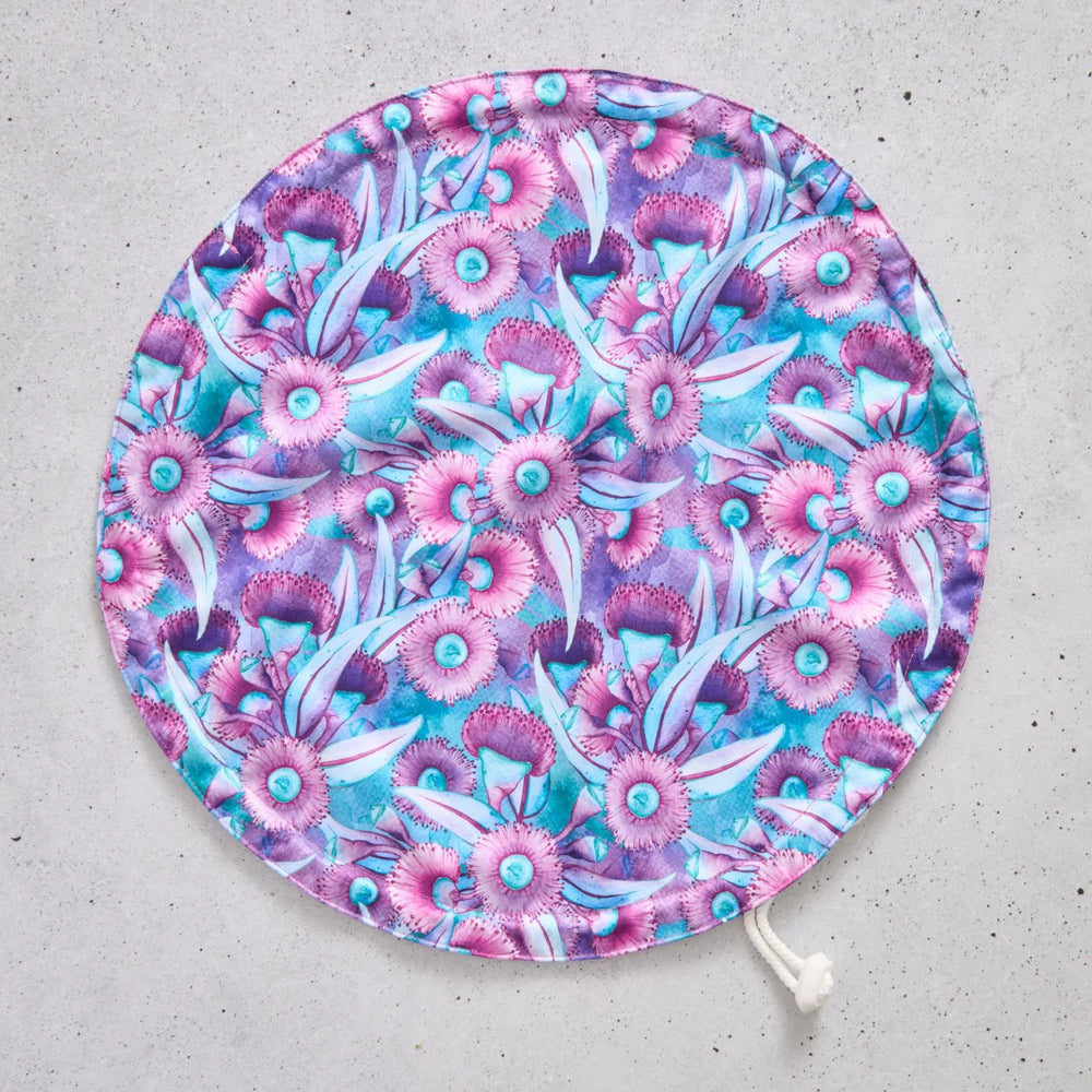 Flat bowl cover with floral pattern on a grey surface