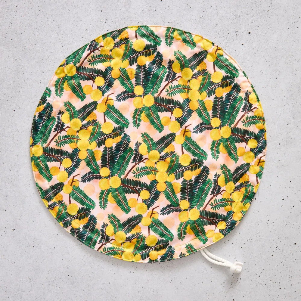 Flat bowl cover with floral pattern on a grey surface