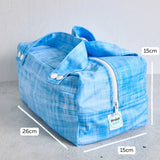 Blue reusable produce bag with measurements on a grey background