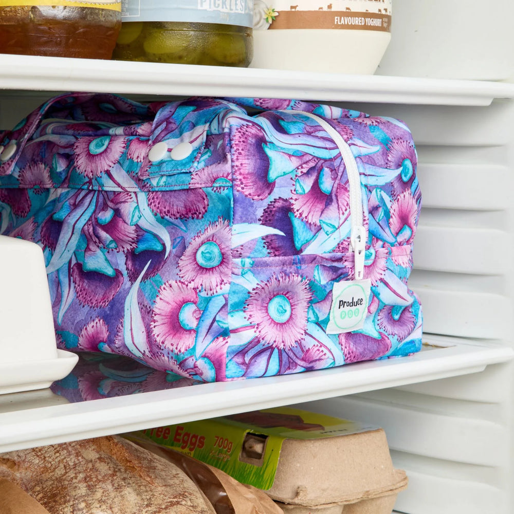 Purple floral reusable produce bag on a fridge shelf