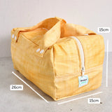 Yellow reusable produce bag with measurements on a grey background