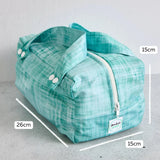 Teal reusable produce bag with measurements on a grey background