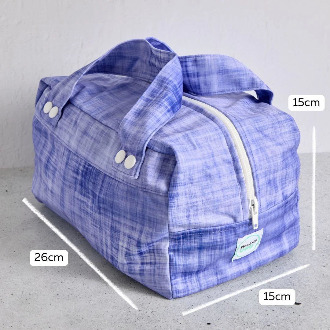 Purple reusable produce bag with measurements on a grey background