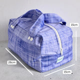 Purple reusable produce bag with measurements on a grey background