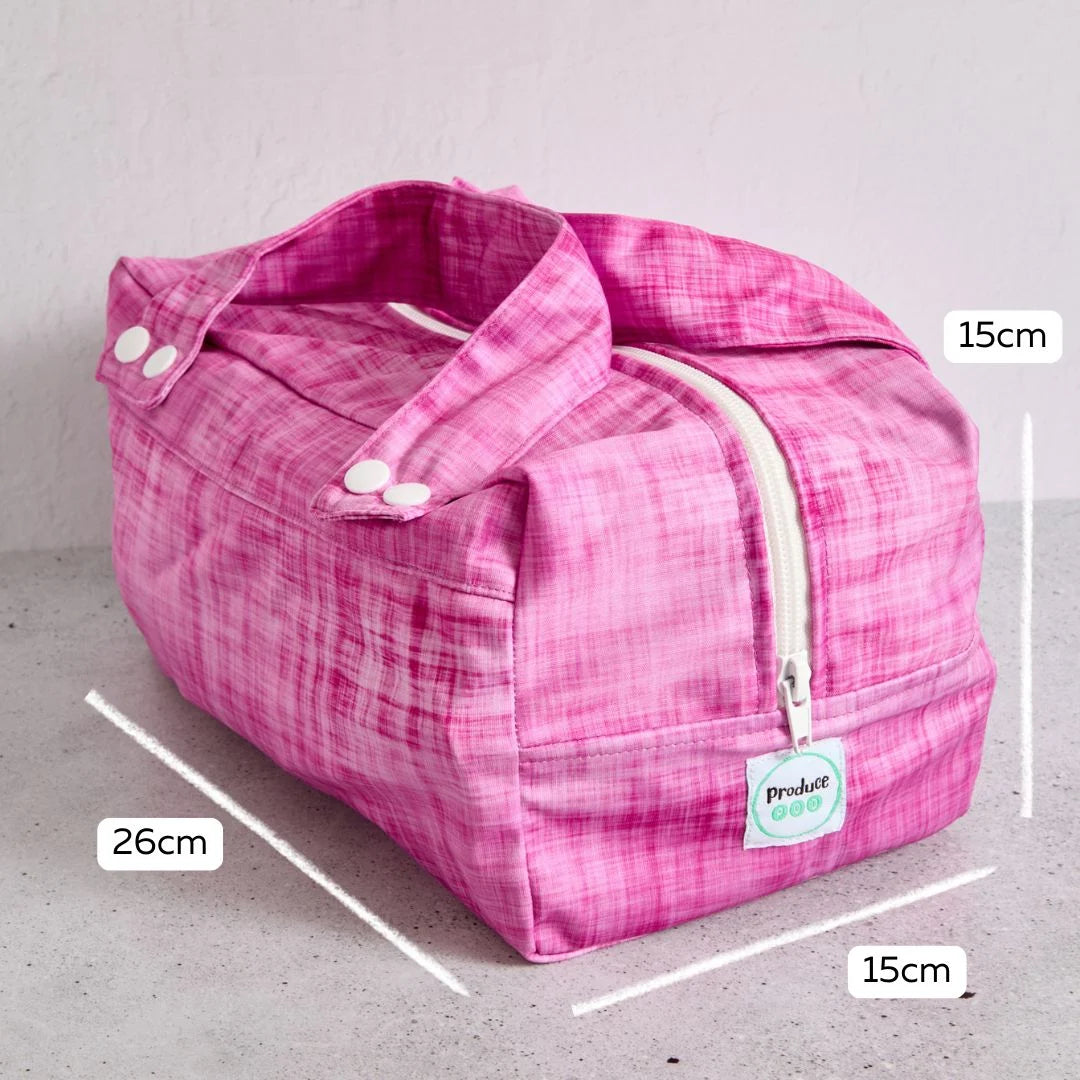 Pink reusable produce bag with measurements on a grey background