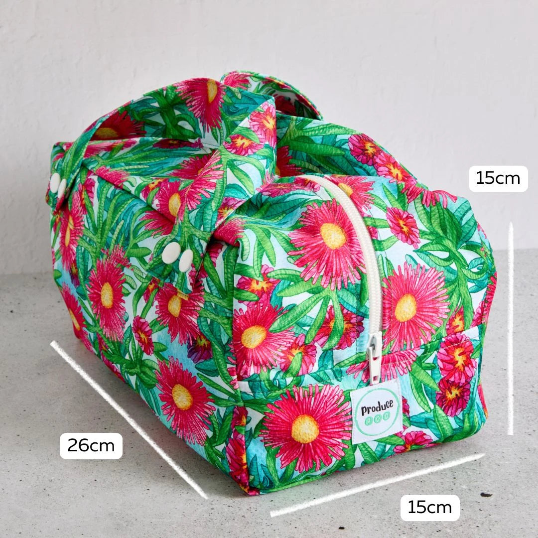 Floral-patterned reusable produce bag with measurements on a grey background