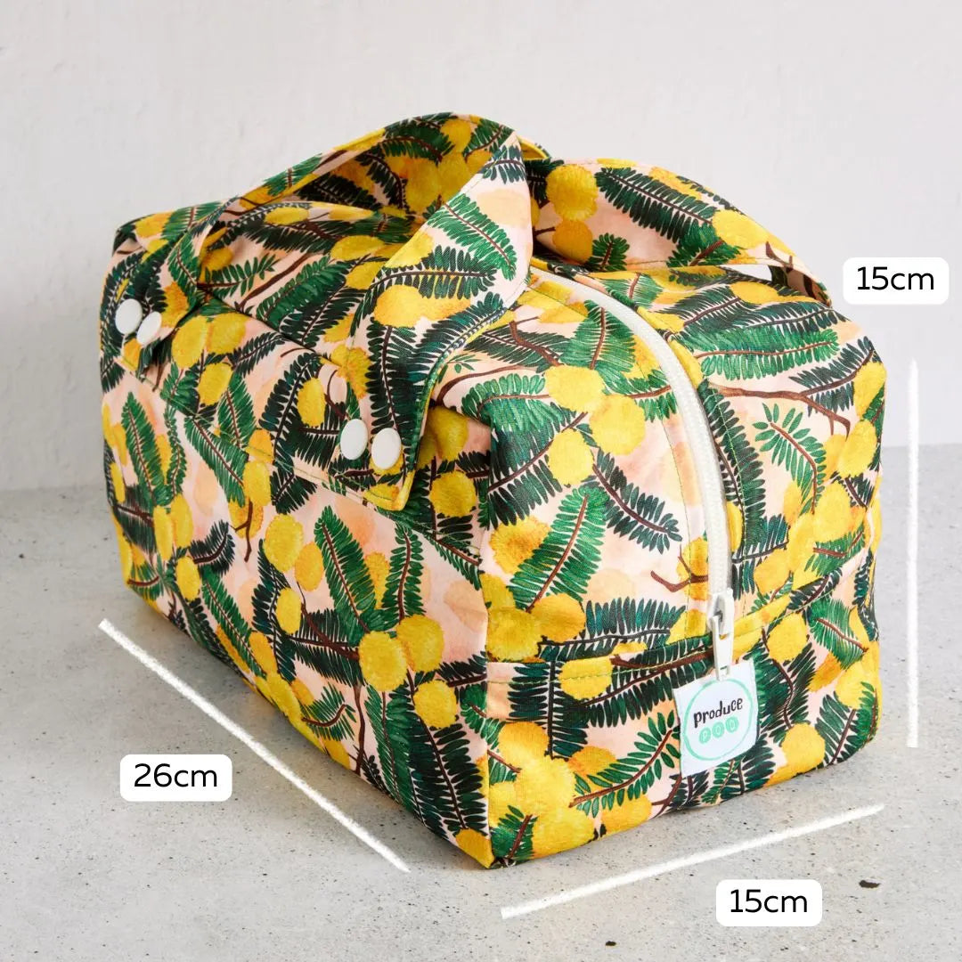 Floral-patterned reusable produce bag with measurements on a grey background