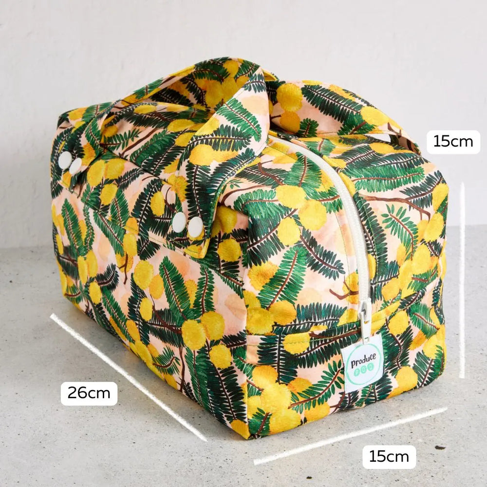 Floral-patterned reusable produce bag with measurements on a grey background